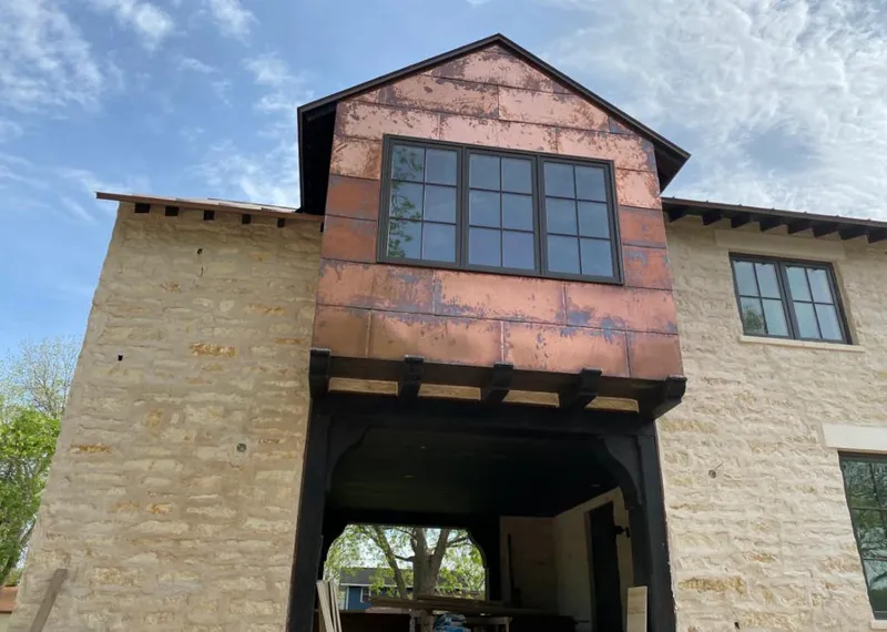 Copper metal panel facade on a stone building for Metal Roof Coating in Greeneville